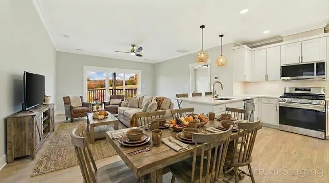 a living room with furniture a flat screen tv and kitchen view