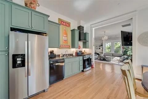 a kitchen with stainless steel appliances granite countertop a refrigerator stove and sink