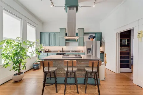 a dining room with furniture potted plants and wooden floor