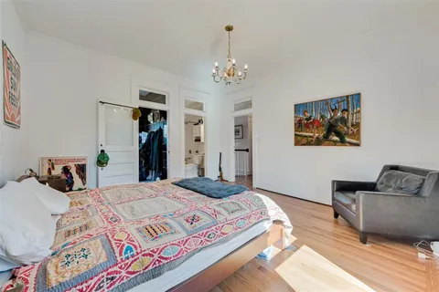 a bedroom with bed and a chandelier