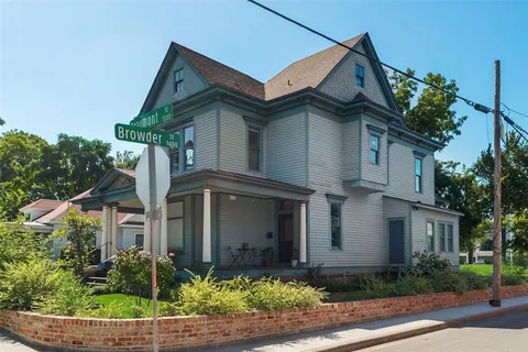 a front view of a house with plants