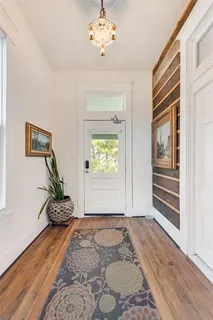 a view of an entryway with wooden floor