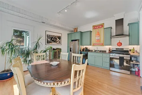a dining room with furniture and wooden floor