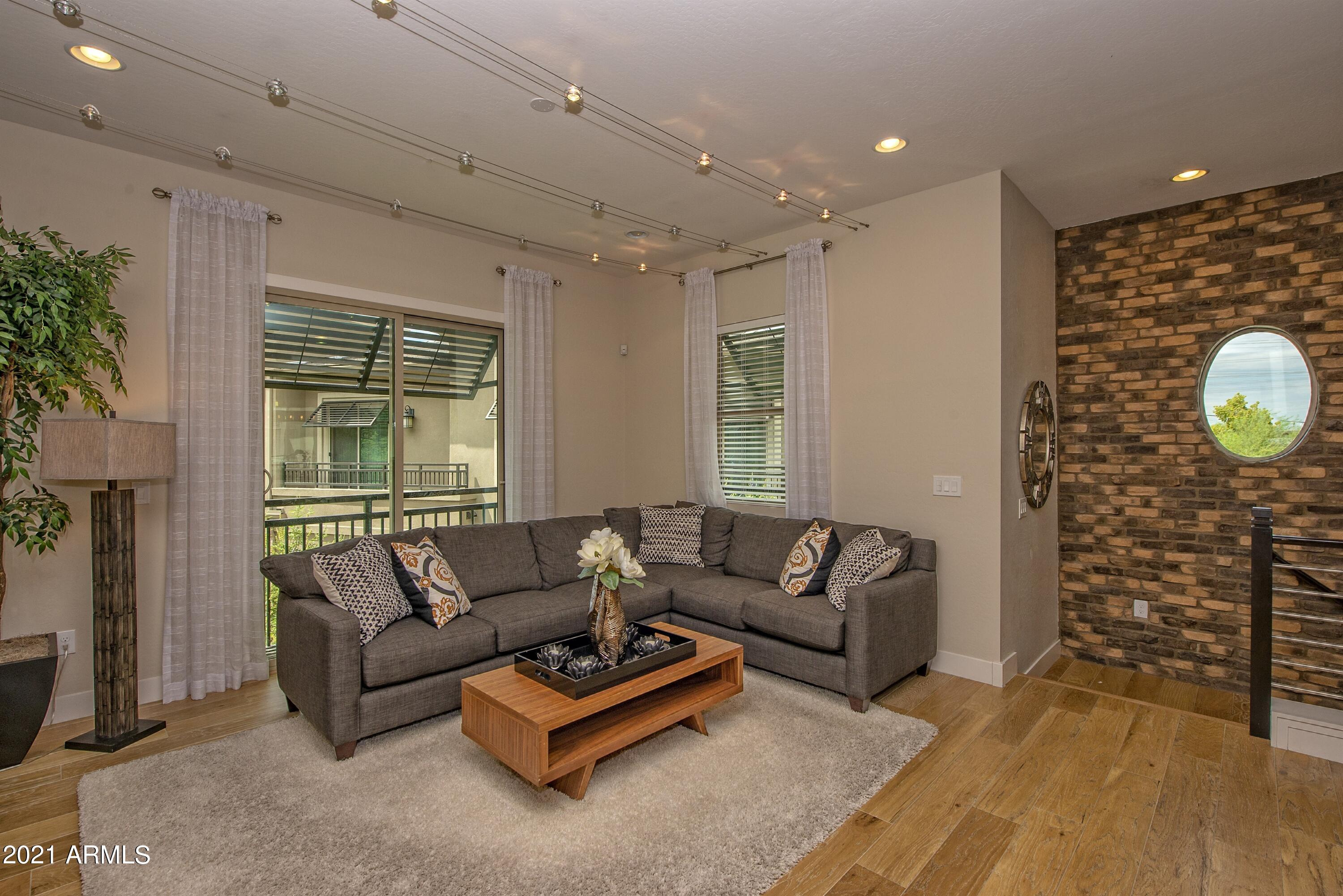 6565 East Thomas Road, Unit 1042 Scottsdale, AZ 85251 - Photo 2 of 22 a living room with furniture and a large window