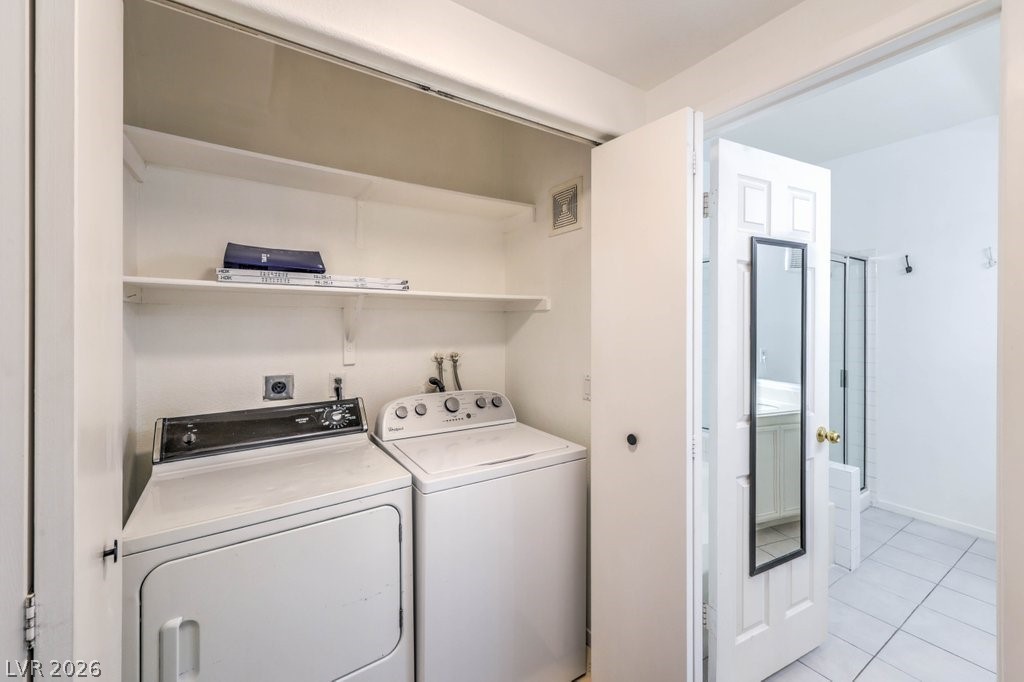 2201 Ramsgate Drive, Unit 1017 Henderson, NV 89074 - Photo 20 of 30 This dedicated laundry closet features convenient shelving, seamlessly connecting to an adjacent tiled bathroom.