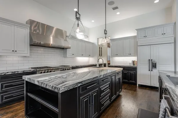 a kitchen with a stove and a wooden floor
