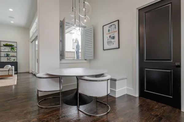 a dining room with wooden floor and breakfast area