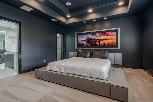 a bedroom with a bed and glass door