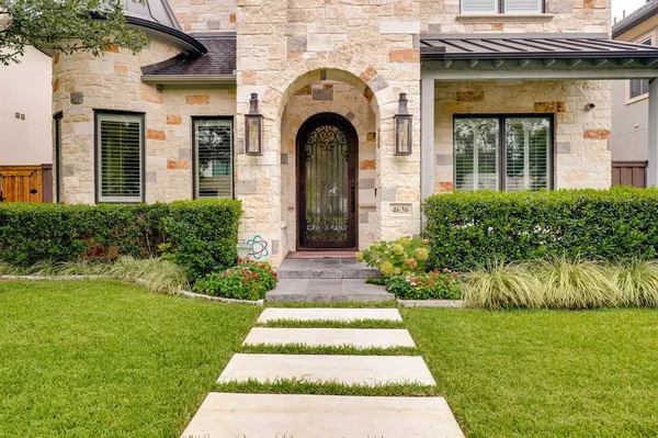 a front view of a house with a garden