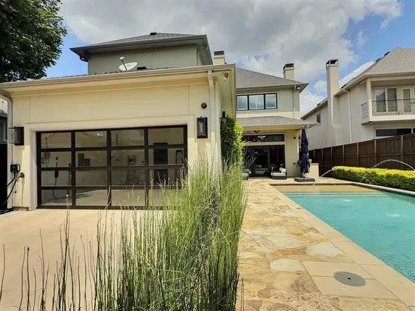 a view of a house with a small yard and wooden floor and fence