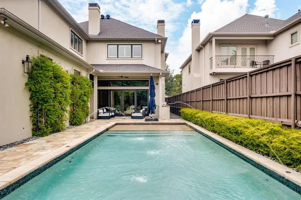 a view of swimming pool with a patio and a yard