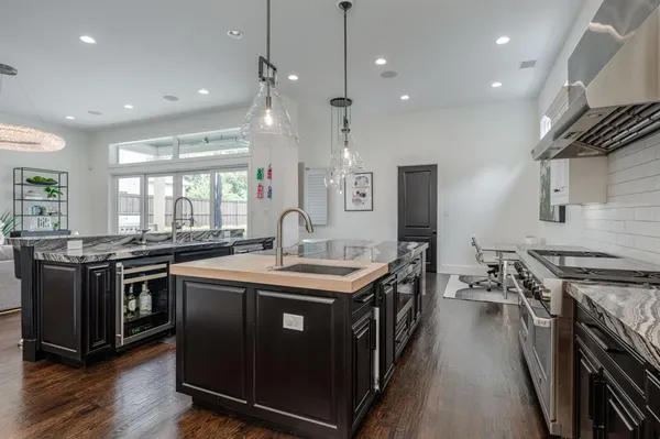 a kitchen with stainless steel appliances granite countertop a stove and a sink