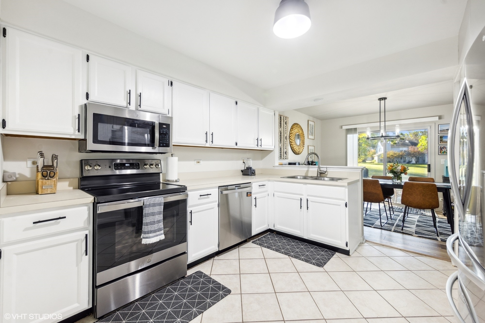732 Bent Ridge Lane Elgin, IL 60120 - Photo 3 of 25 a kitchen with a stove a sink and a microwave