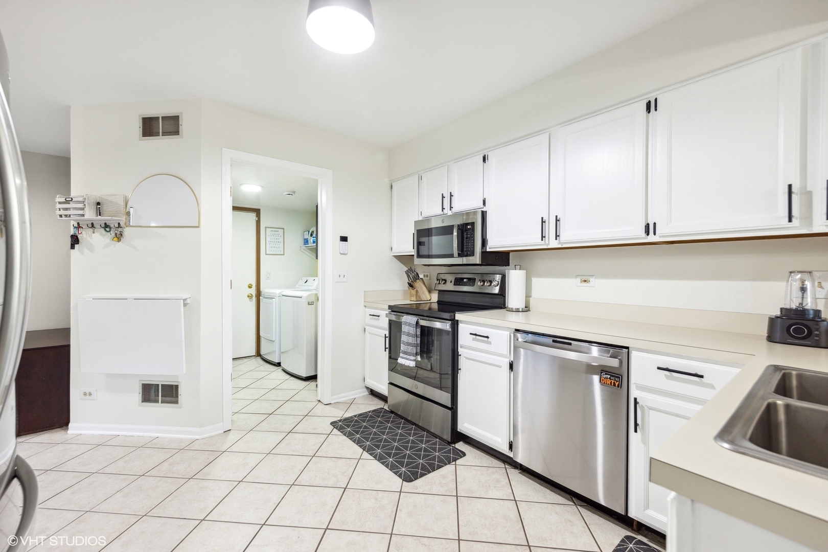 732 Bent Ridge Lane Elgin, IL 60120 - Photo 5 of 25 a kitchen with white cabinets and white appliances