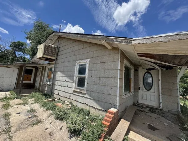 a living room with furniture a window and a flat screen tv