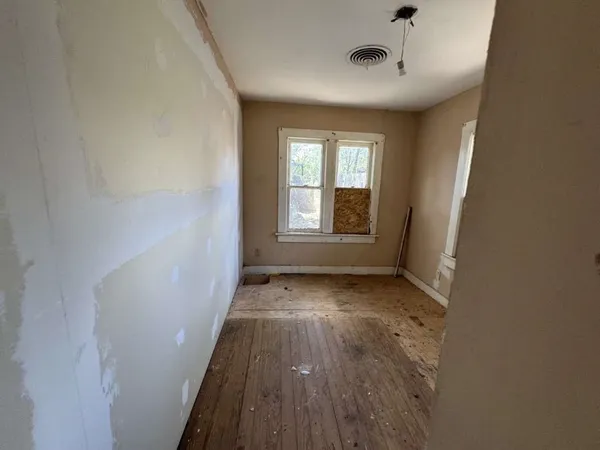 a bathroom with a toilet and a mirror