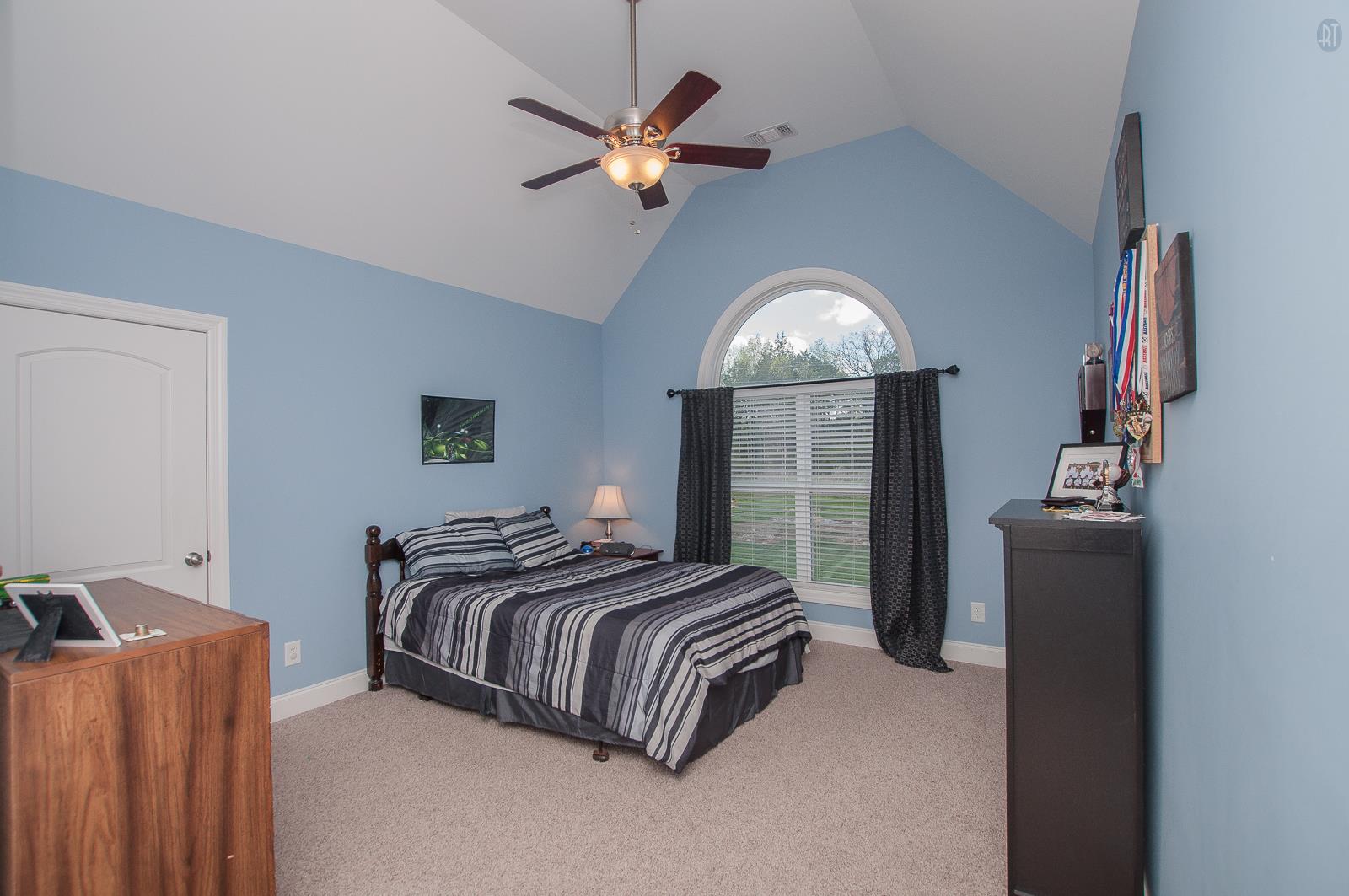 2172 Holloway Road Lebanon, TN 37090 - Photo 13 of 21 a spacious bedroom with a bed and a chandelier