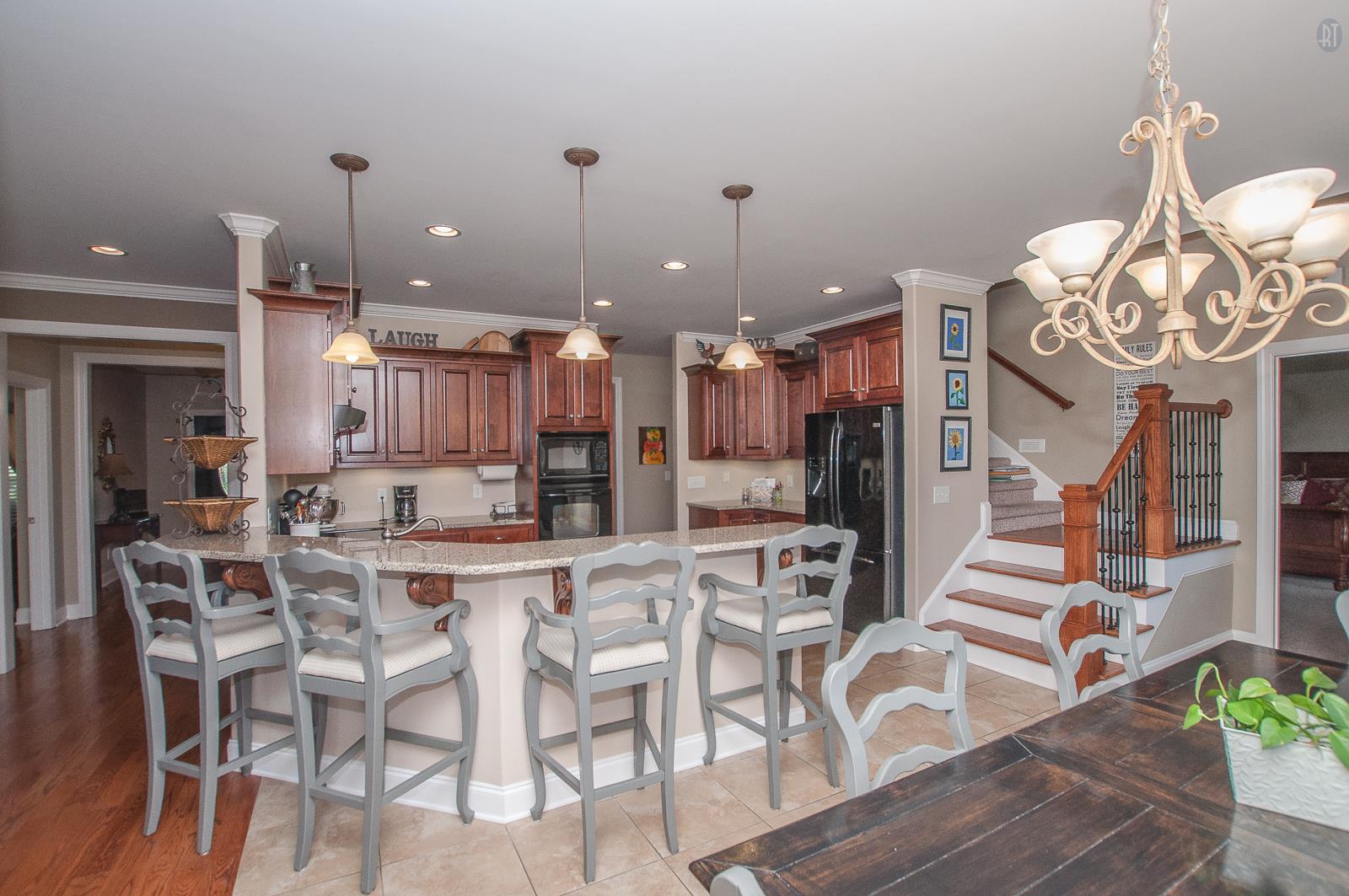 2172 Holloway Road Lebanon, TN 37090 - Photo 2 of 21 a kitchen with stainless steel appliances kitchen island granite countertop a table chairs and a chandelier