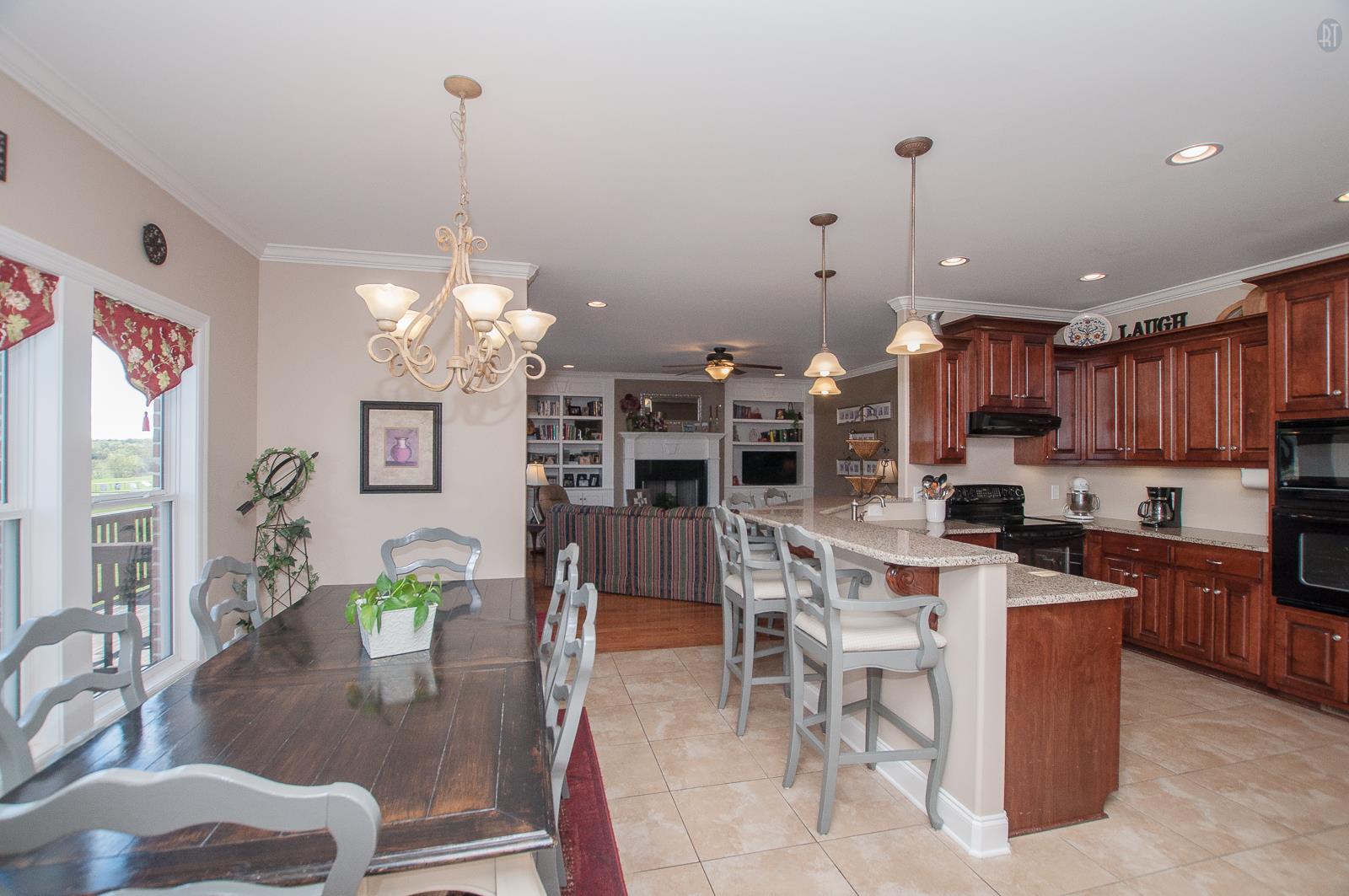 2172 Holloway Road Lebanon, TN 37090 - Photo 3 of 21 a kitchen with stainless steel appliances kitchen island granite countertop a table and chairs