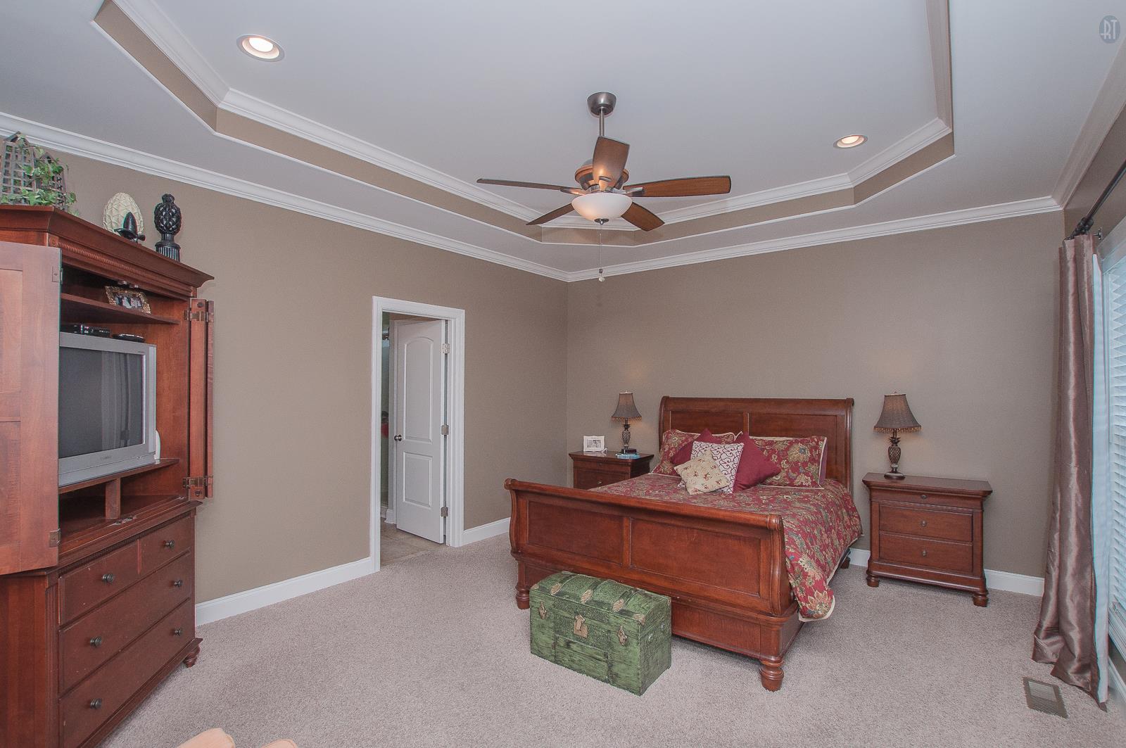 2172 Holloway Road Lebanon, TN 37090 - Photo 8 of 21 a bedroom with a bed and a chandelier