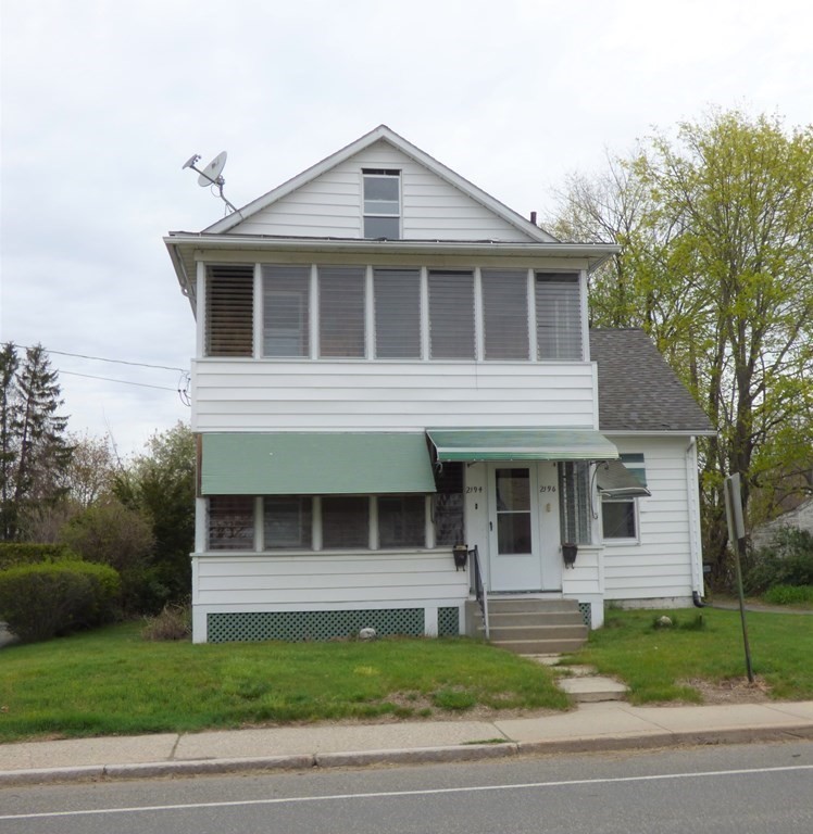2194-2196 Main Street Three Rivers, MA 01080 - Photo 2 of 28 a front view of a house with a yard