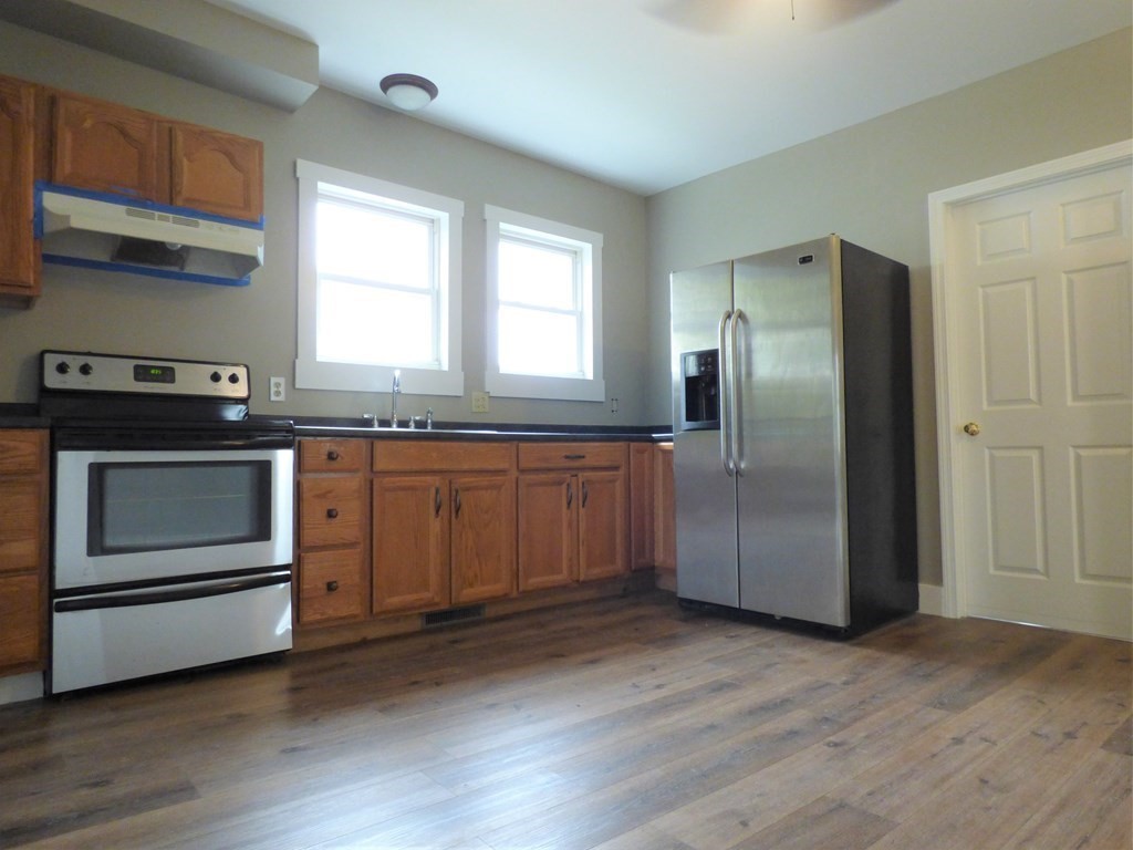 2194-2196 Main Street Three Rivers, MA 01080 - Photo 10 of 28 a kitchen with granite countertop stainless steel appliances and wooden cabinets