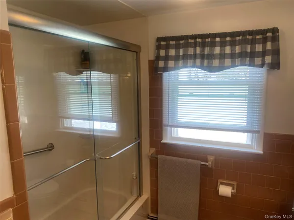 a bathroom with a shower and a window