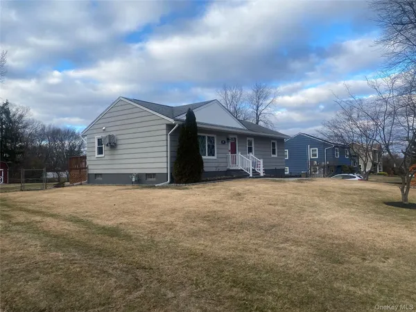a view of a house with a yard and garage