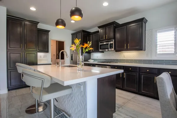 a kitchen with stainless steel appliances a sink and cabinets