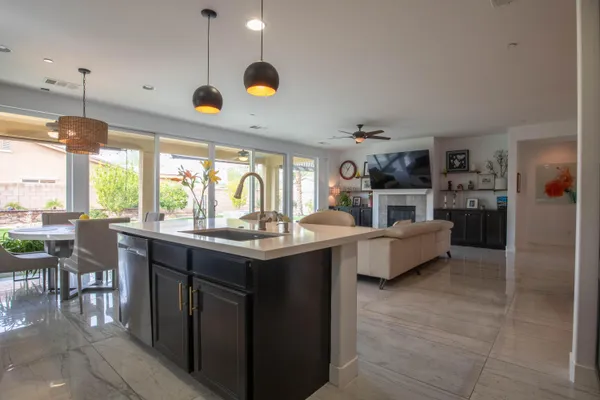 a kitchen with kitchen island a sink stainless steel appliances and cabinets