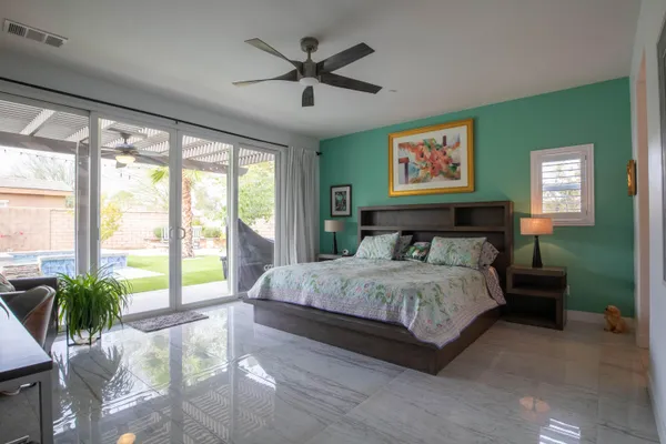 a spacious bedroom with a large bed and a large window
