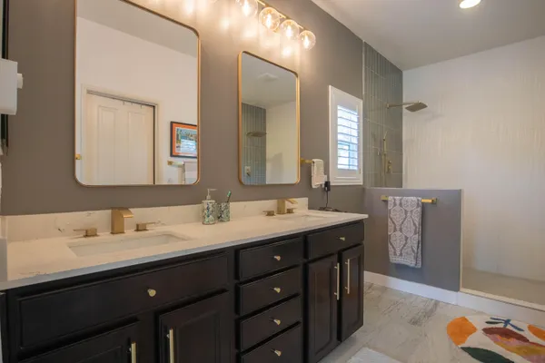 a bathroom with a double vanity sink and a mirror