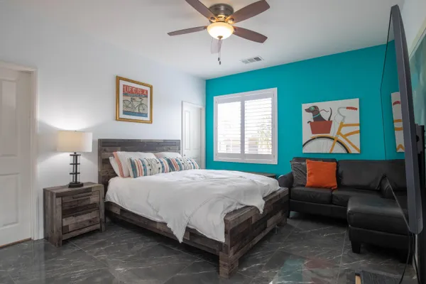 a bedroom with a bed and a chandelier