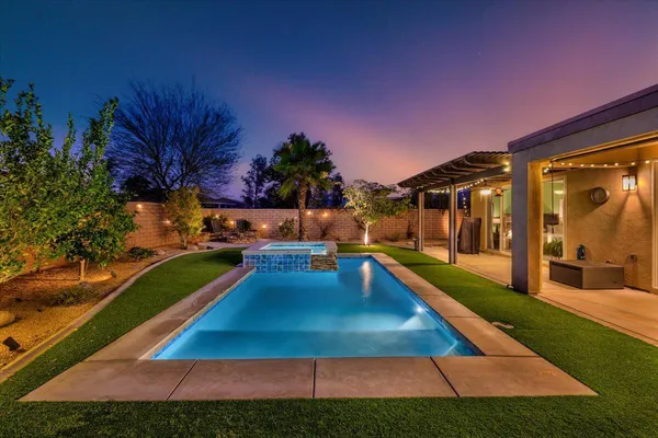 a swimming pool with outdoor seating and yard