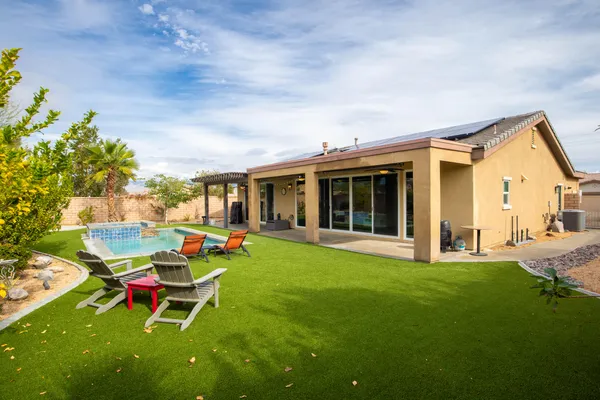 a view of a house with backyard porch and sitting area