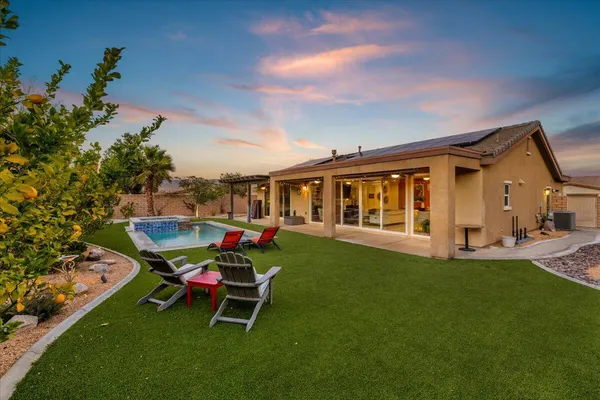 a view of a house with a backyard