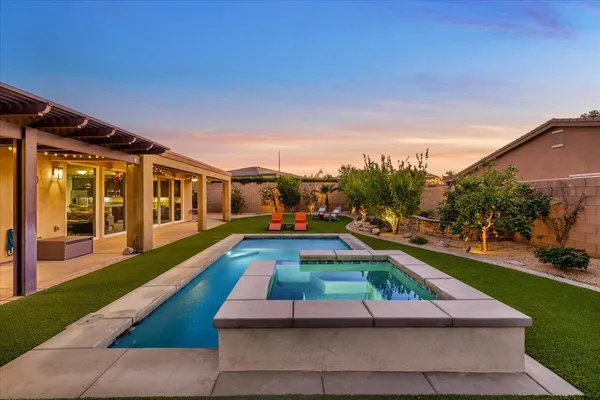 a room with pool table and chairs