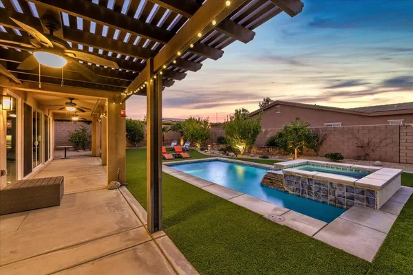 a view of swimming pool with seating area and furniture