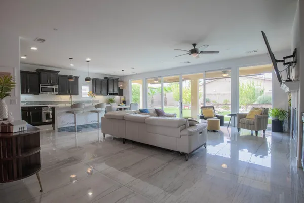 a living room with furniture a fireplace and a flat screen tv