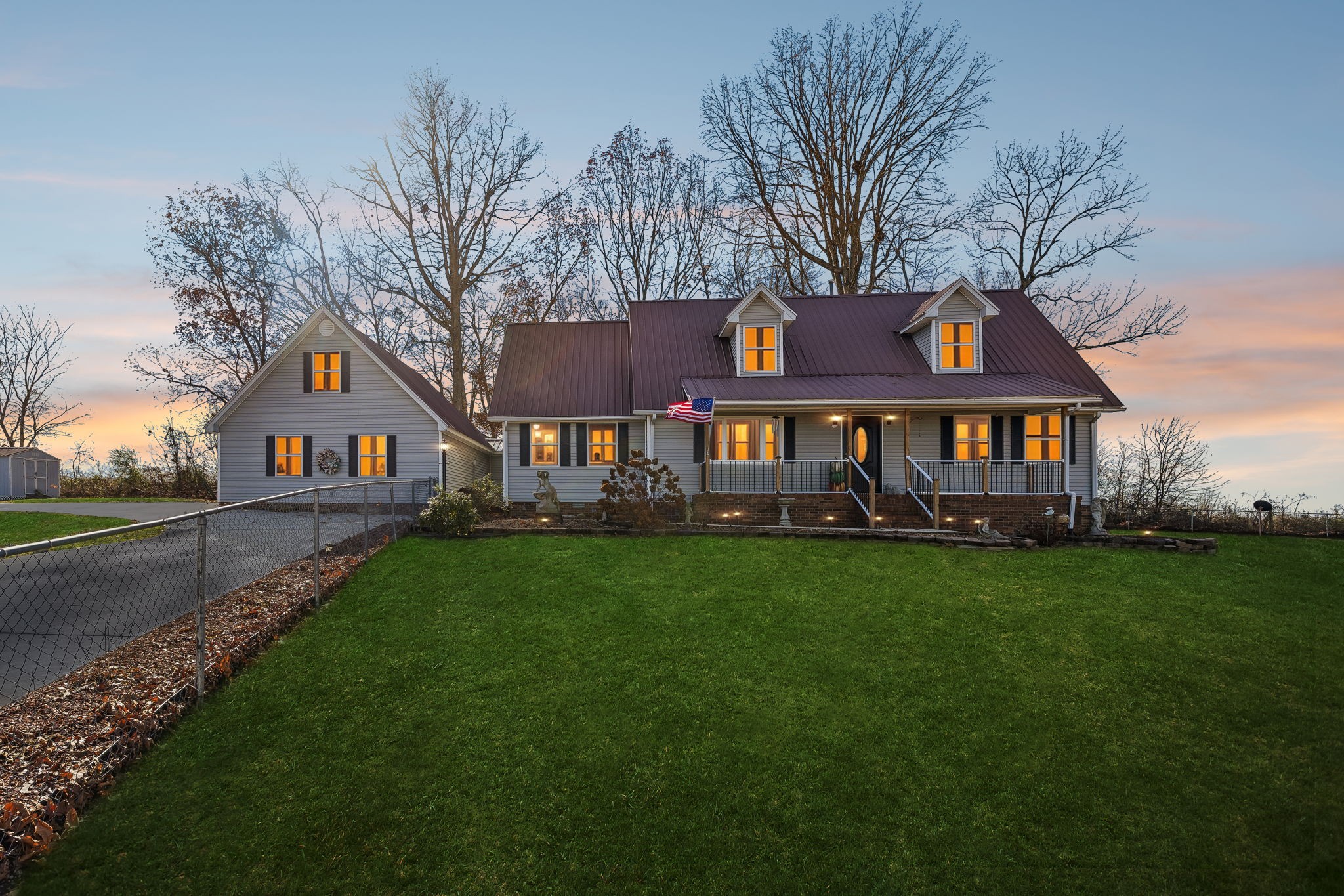 a front view of house with yard and green space