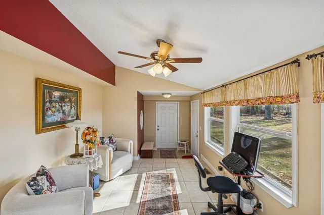 a living room with furniture a fireplace and a flat screen tv