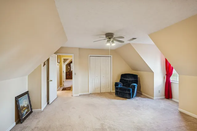 a view of a livingroom with a furniture and a ceiling fan