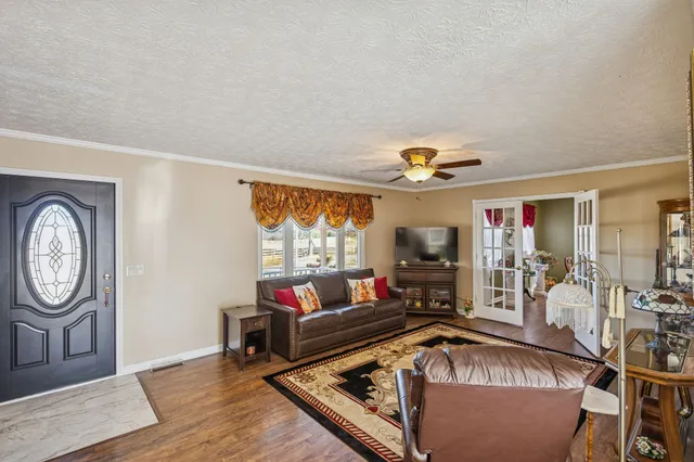 a living room with furniture a window and a flat screen tv