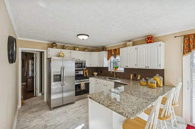a kitchen with a refrigerator a sink and dishwasher