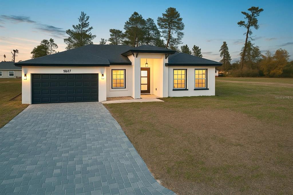16697 Southwest 23rd Avenue Road Ocala, FL 34473 - Photo 1 of 1 a front view of a house with a yard and garage