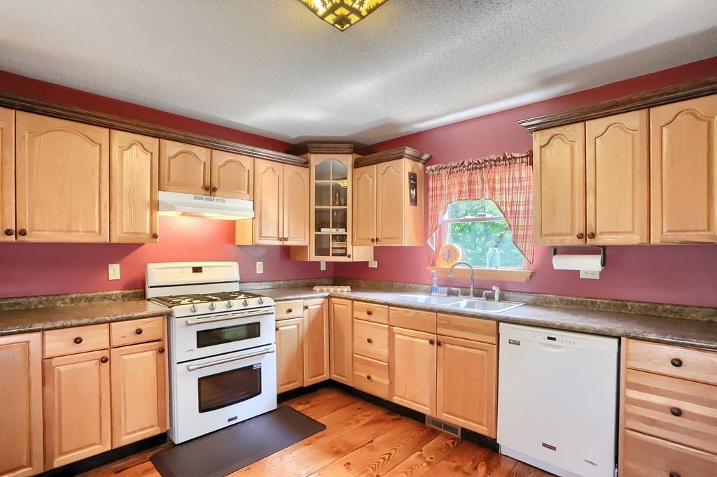 3508 Canoe Ripple Road Sligo, PA 16255 - Photo 54 of 75 a kitchen with stainless steel appliances a stove sink and cabinets