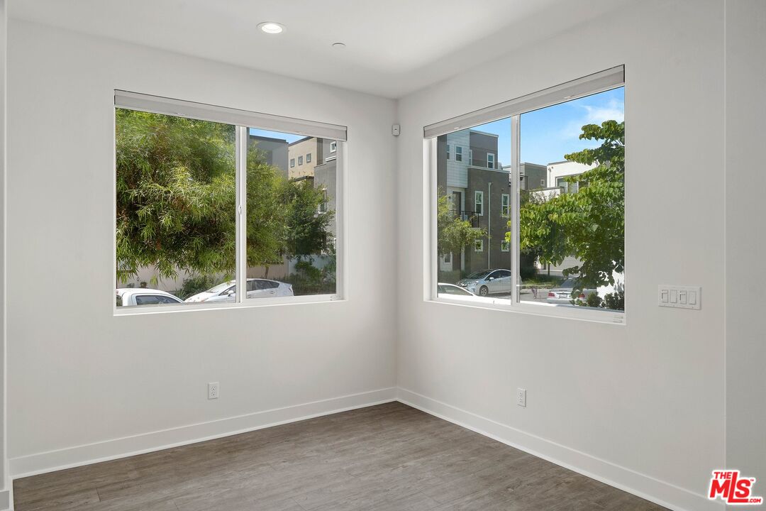 659 Daniel Freeman Circle Inglewood, CA 90301 - Photo 12 of 34 a view of an empty room with wooden floor and a window