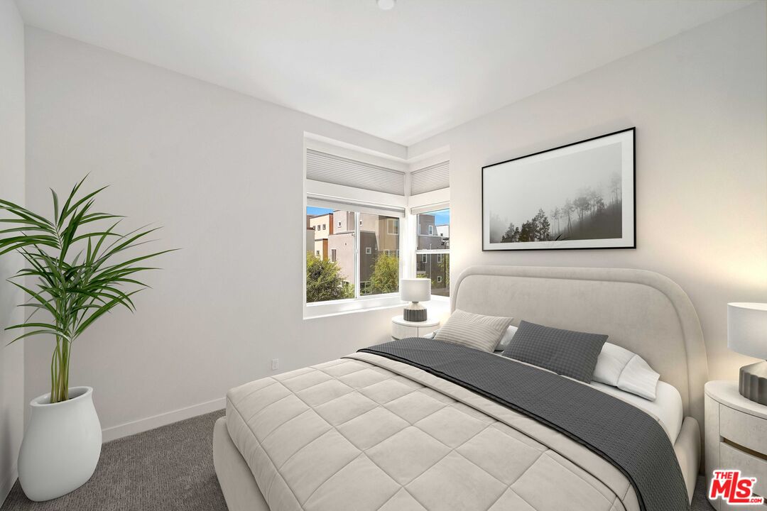 659 Daniel Freeman Circle Inglewood, CA 90301 - Photo 17 of 34 a bedroom with a large bed and a potted plant