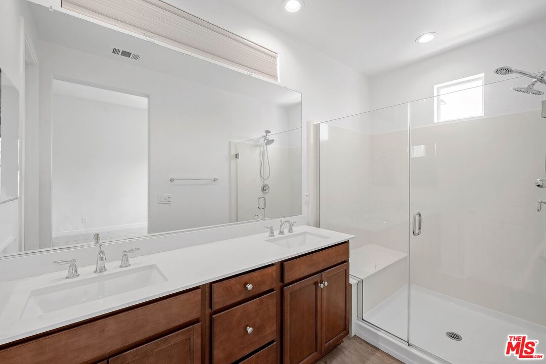 659 Daniel Freeman Circle Inglewood, CA 90301 - Photo 20 of 34 a bathroom with a shower sink double vanity and a mirror