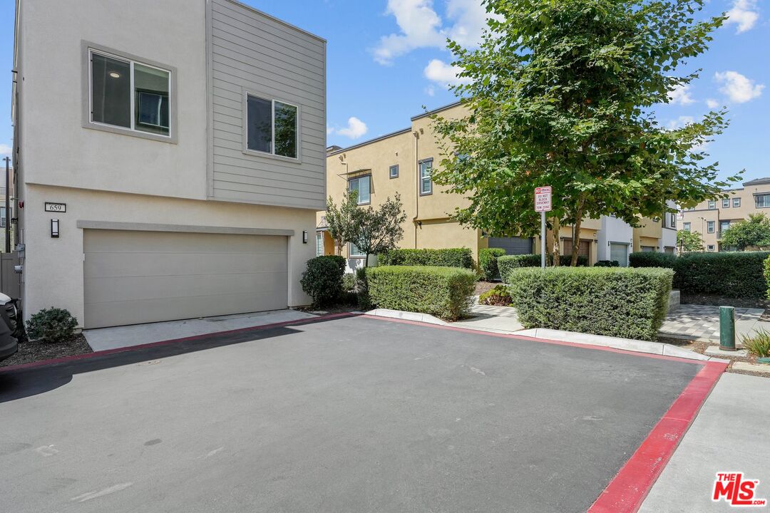 659 Daniel Freeman Circle Inglewood, CA 90301 - Photo 28 of 34 a front view of a house with a yard and a garage